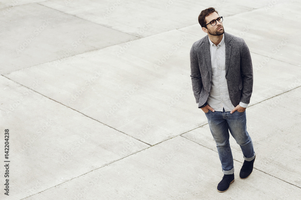 Handsome man walking on grey paving stones Handsome man walking on grey paving stones