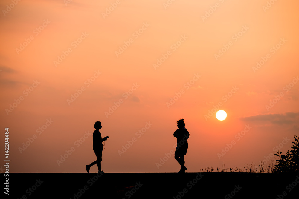 silhouette girl relax on beautiful sunset background