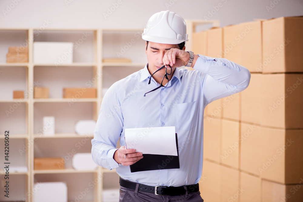 Young worker in the postal office dealing with parcels Young worker in the postal office dealing with parcels