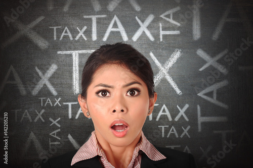 Shocked asian business woman with tax anoucement photo