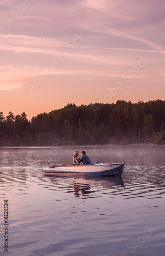 Romantic golden sunset river lake fog loving couple small rowing boat date beautiful Lovers ride during Happy woman man together relaxing water nature around © marmoset