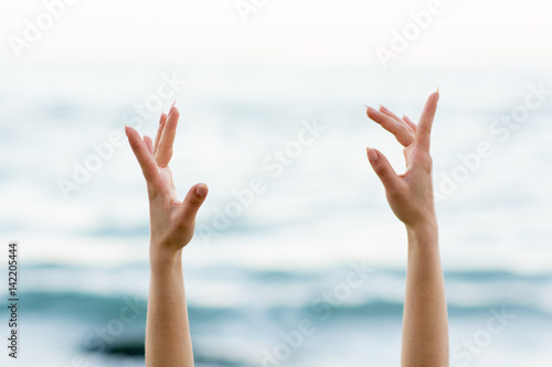 Woman's hands in front of the sea