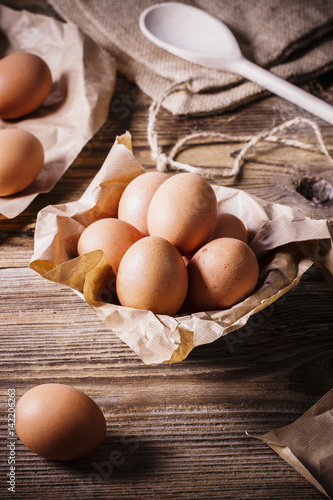 Eggs in a bowl on a wooden table