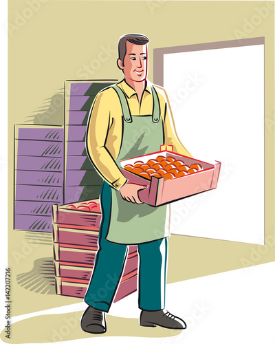 Young man moves a crate full of oranges