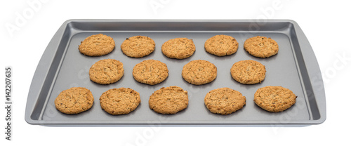 Obraz na plátně Oatmeal cookies on a baking sheet isolated on a white background.