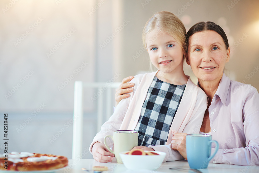 Affectionate girl and her grandmother at home Affectionate girl and her grandmother at home