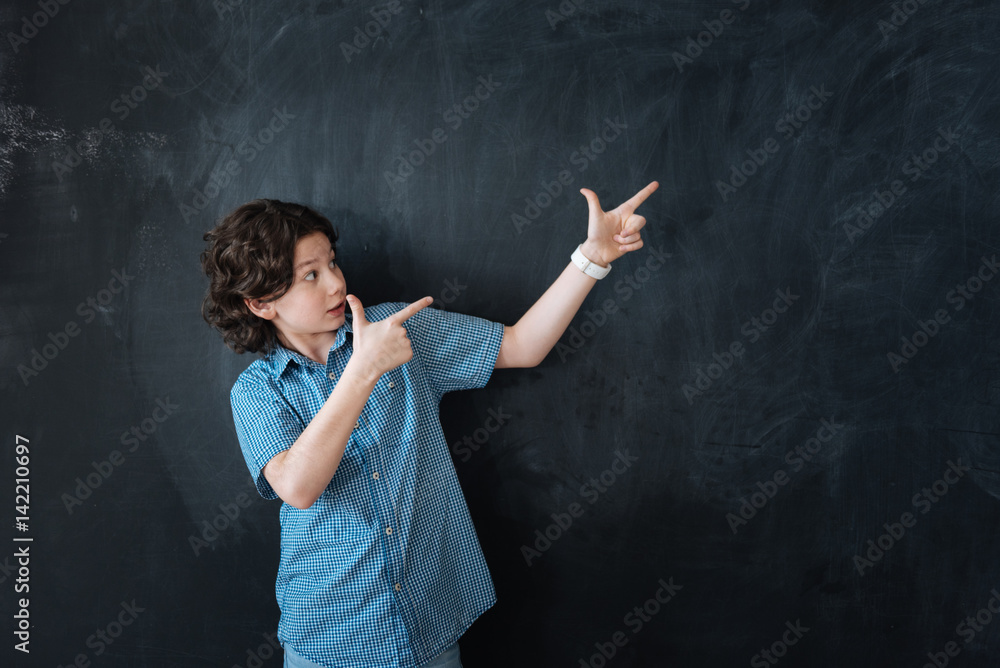 Artisitc boy giving advice in the black colored studio