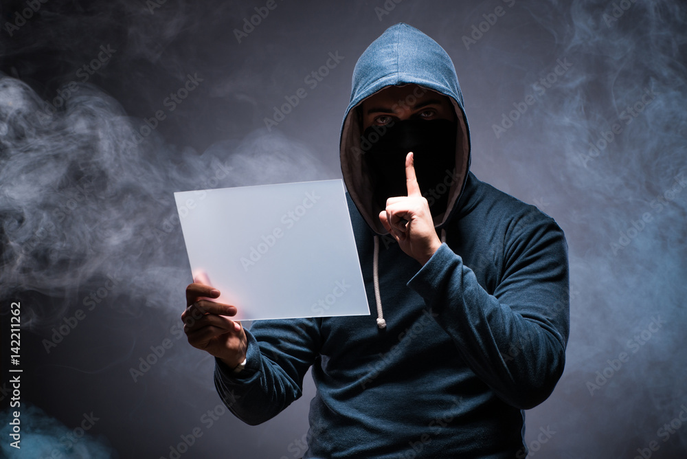 Naklejka premium Hacker working on tablet in dark