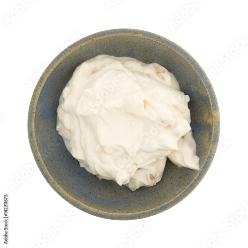 Apple Greek yogurt in a stoneware bowl isolated on a white background.