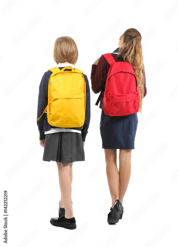 Two cute girls in school uniform on white background Two cute girls in school uniform on white background