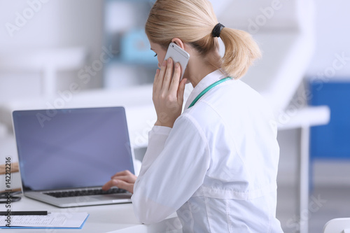 Female doctor at work in cl...