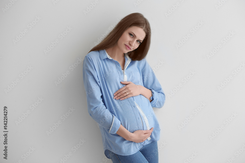 Beautiful pregnant woman on light background Beautiful pregnant woman on light background