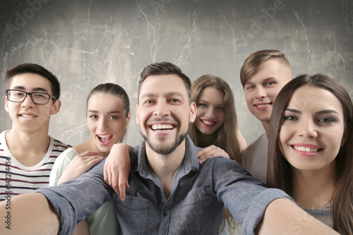 Happy young friends taking ...