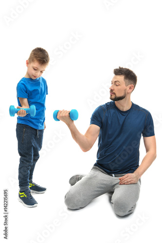 Father and son with dumbbel...