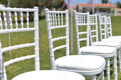 Special event decorated area and white furniture on the green grass sunny outside background