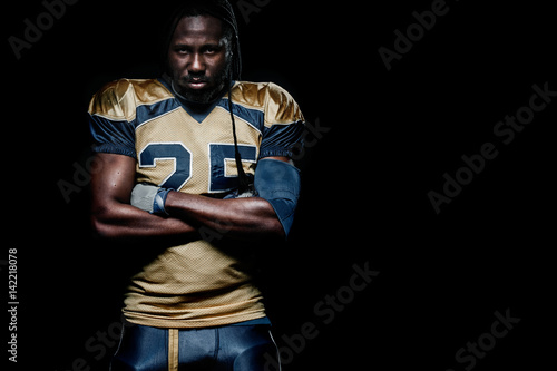 American football sportsman player isolated on black background with copy space