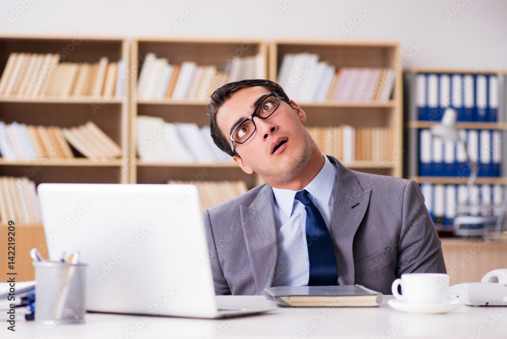 Angry businessman working in the office Angry businessman working in the office