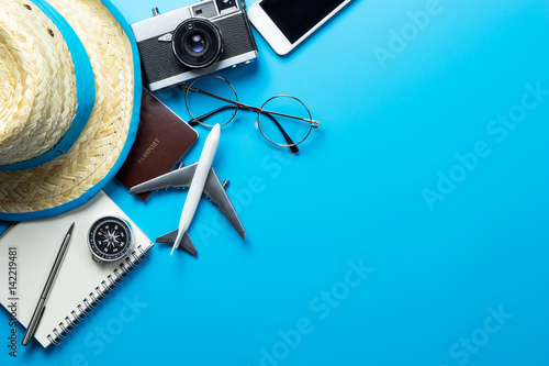 Travel accessories with copy space on blue background