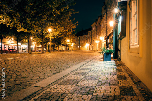 Mysterious square with lanterns in Prague at night.