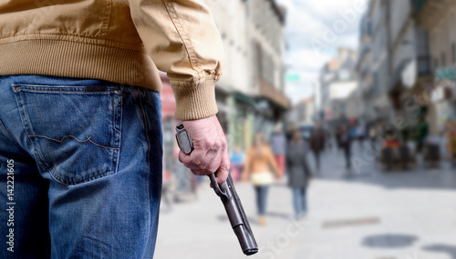 Canvas-taulu killer man is attacking with  gun on public place