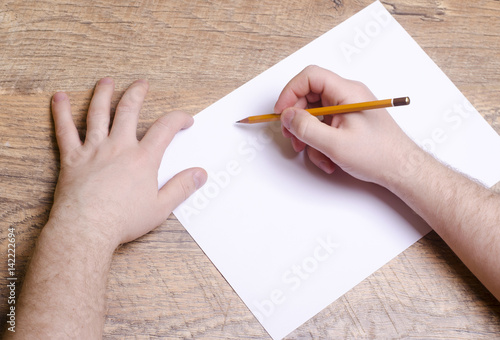 Humans hand holding pencil background