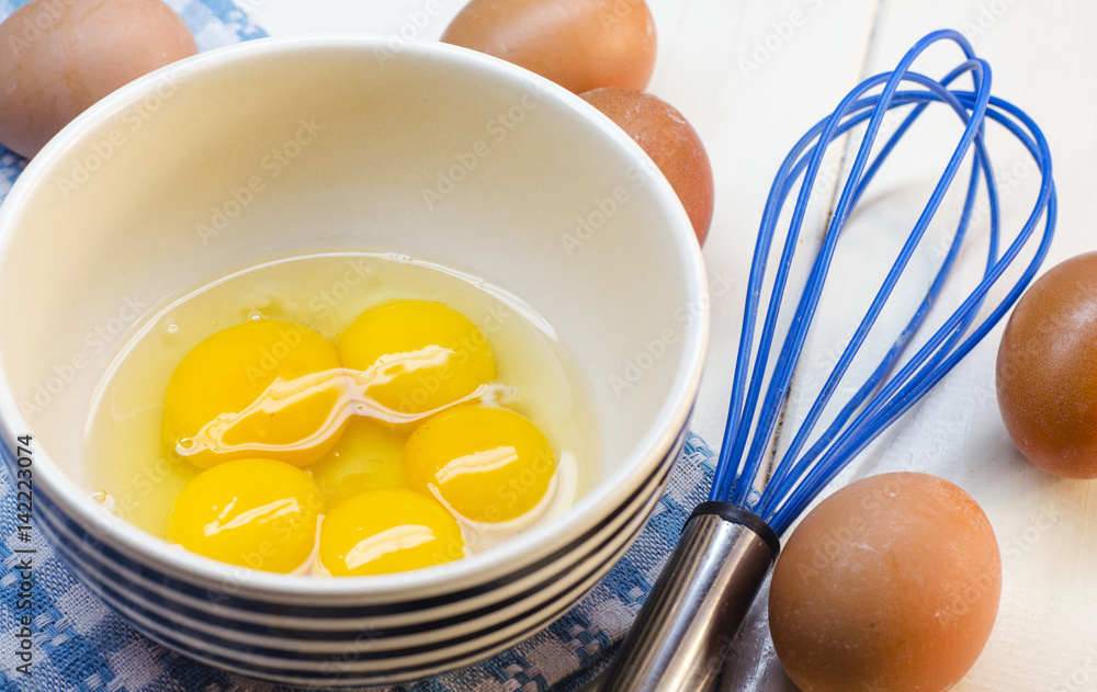 Raw eggs and whisk Raw eggs and whisk