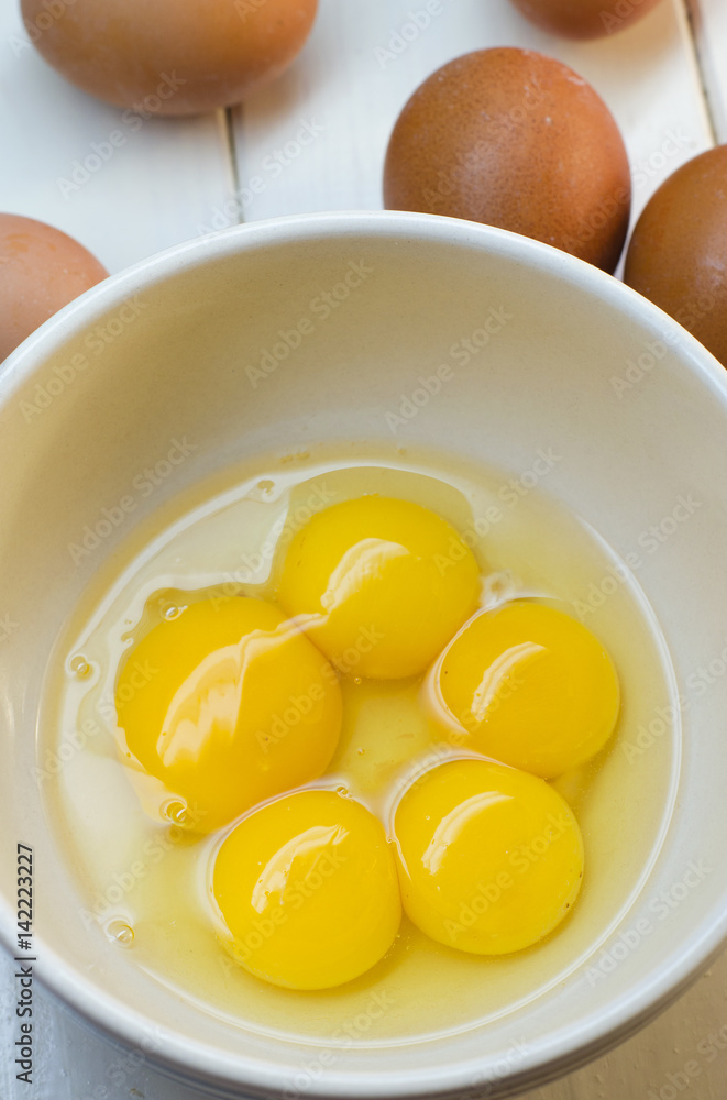 Raw eggs on a white background