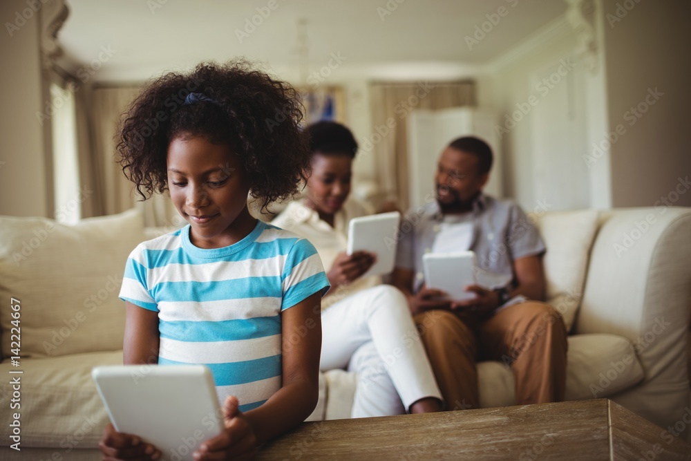 Family using digital tablet in living room