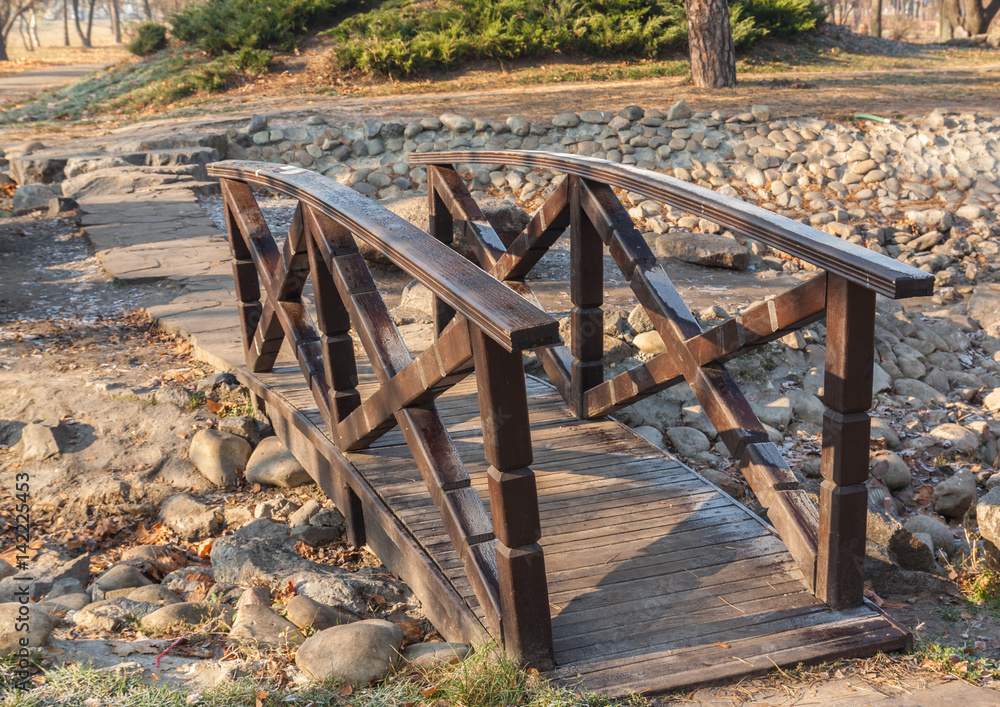 Fototapeta premium Wooden stylized eastern bridge in the Japanese garden