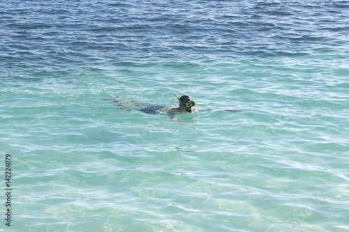 Caucasian man snorkeling in the turquoise water. Caribbean sea.
