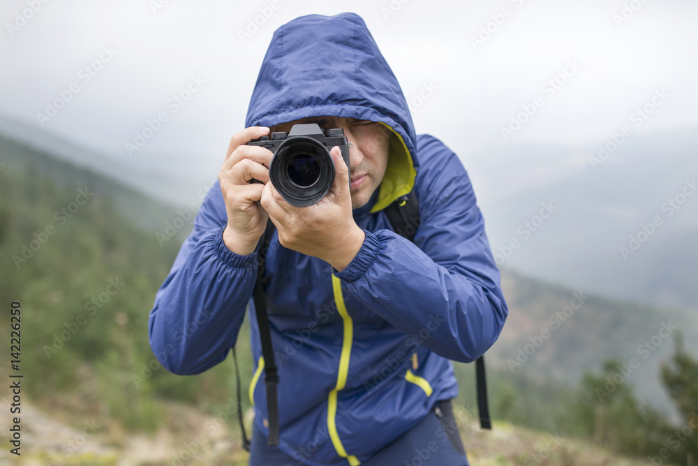 Nature photographer taking photos in the mountains. Nature photographer taking photos in the mountains.