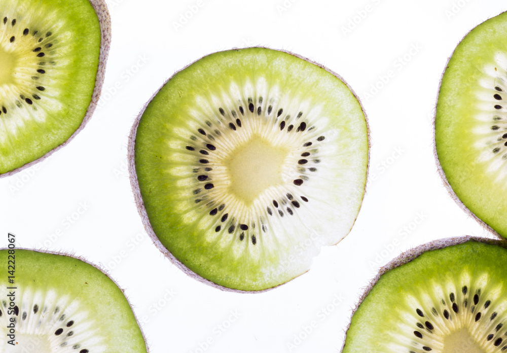 Fototapeta premium Transparent kiwifruit slices close-up on the white