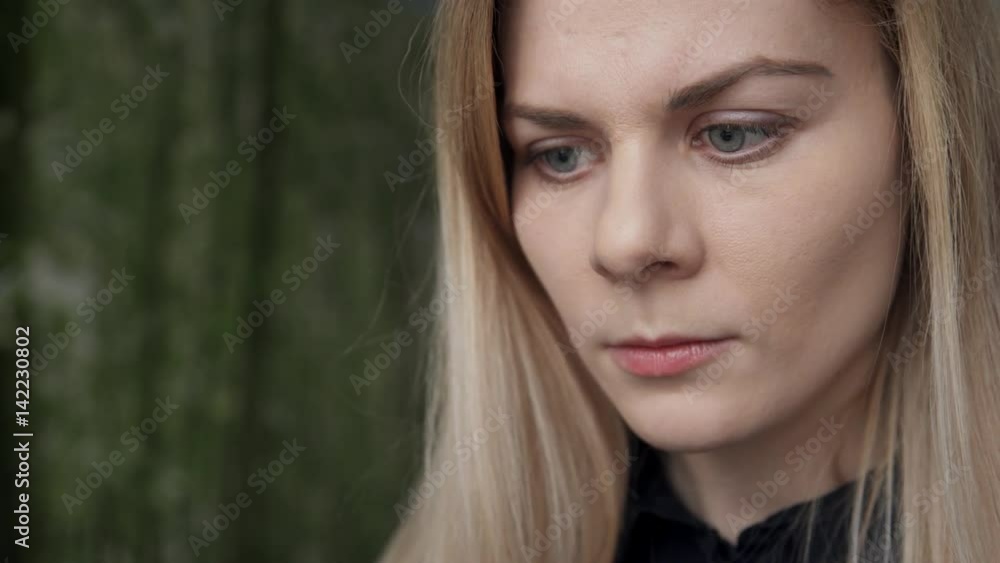 Woman concentrated view of considering reading information on phone. blonde with long straight hair, grey eyes, discreet make-up received message on smartphone from boss, read instructions attentively Woman concentrated view of considering reading information on phone. blonde with long straight hair, grey eyes, discreet make-up received message on smartphone from boss, read instructions attentively