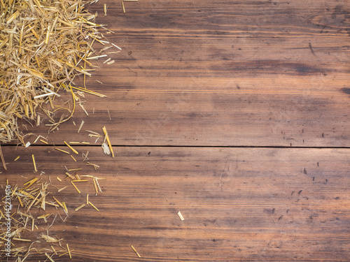 Rural eco background with and straw on the background of old wooden planks. The view from the top. Creative background for greeting cards, menu or advertising photo