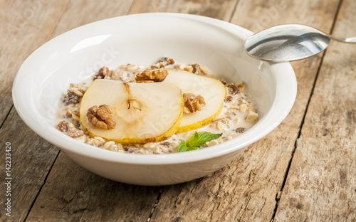 Oatmeal with pear and walnuts in the bowl