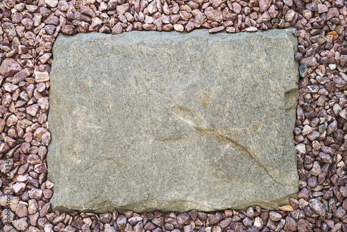 Stone slab around a pebble frame photo