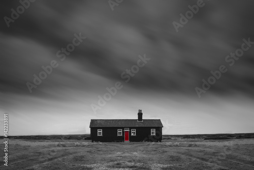 Tablou pe pânză Remote desolate isolated house under dark stormy sky during Winter landscape con