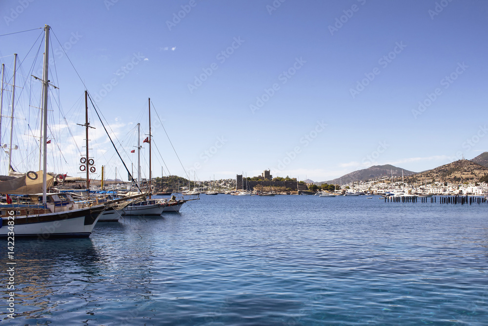 View of wooden yachts and historical, medieval castle in Bodrum city. Stretching from Turkey's southwest coast into the Aegean Sea.