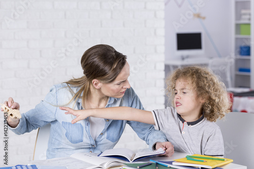 Woman forcing boy to learning