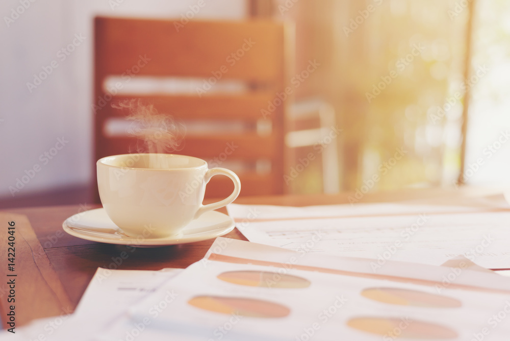 Fototapeta premium Hot coffee on the table with business document