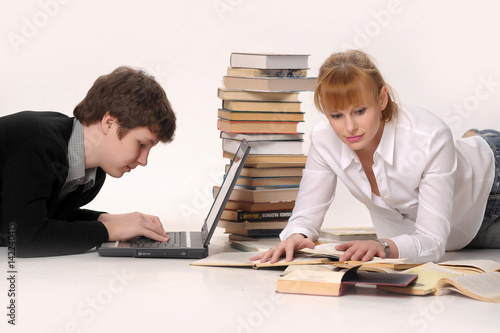 Young man with laptop and woman with books photo