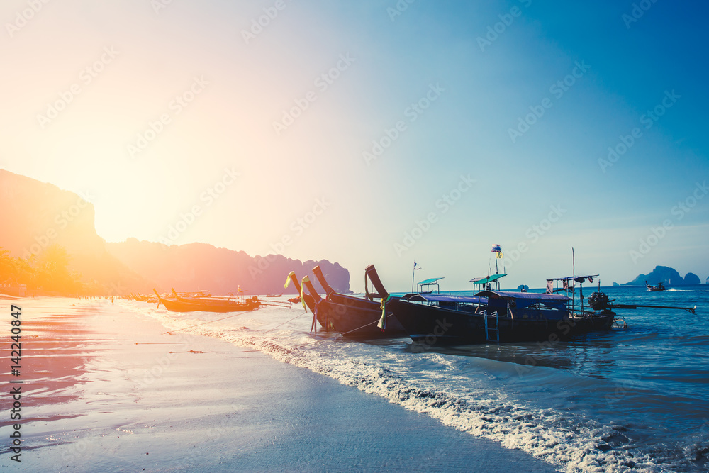 summer sea blue color tone, Thai old wood boat at sea beach sunset sky.