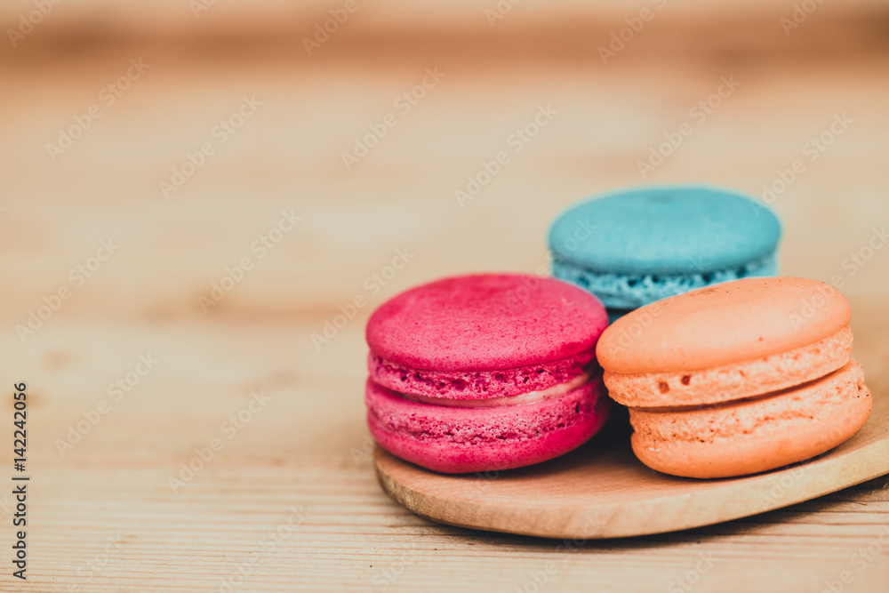 Macaron sweet dessert on wood background dark tone. Macaron sweet dessert on wood background dark tone.