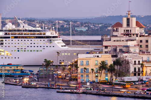 Old Havana at sunset with a view of historic buildings and a modern cruise ship