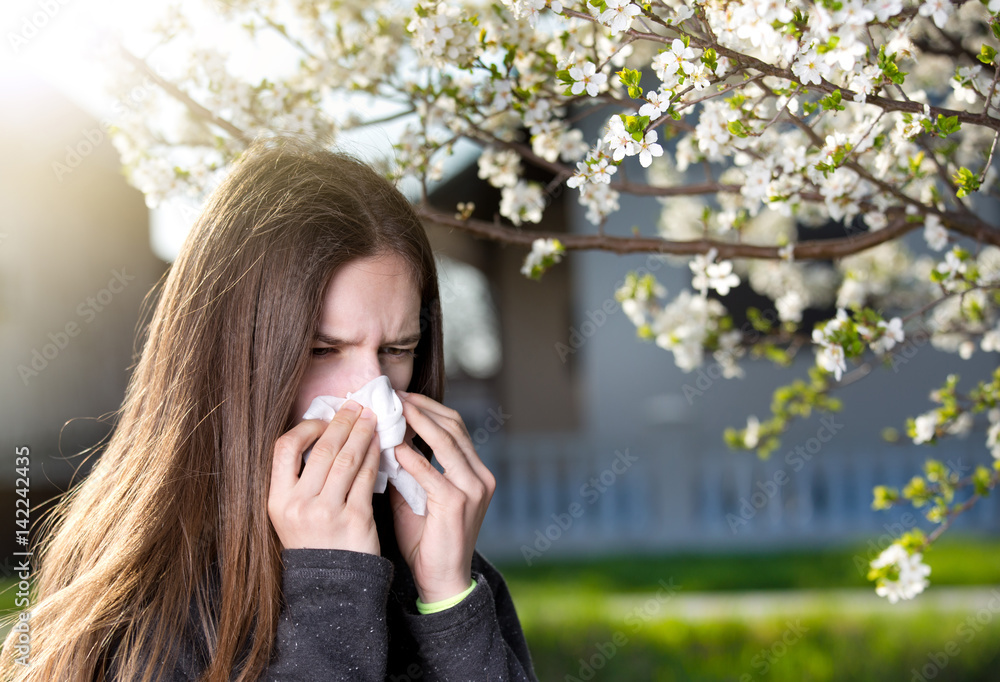 Girl with allergic reaction on blooming tree Girl with allergic reaction on blooming tree