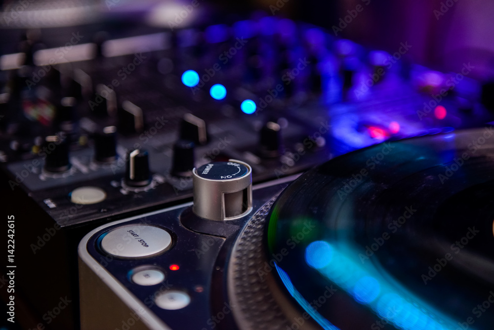 Close up Professional DJ audio equipment - turntable vinyl record player, selective focus.Sound technology for disc jockey to play at concert,party,event Close up Professional DJ audio equipment - turntable vinyl record player, selective focus.Sound technology for disc jockey to play at concert,party,event