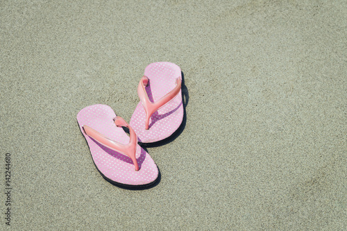 Abstract pink shoes on beach and sand, vacation and holiday concept, with copy space