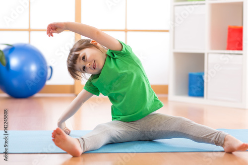 Sportive kid girl doing gym...
