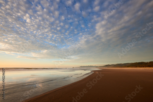 Oregon Coast at Sunset. View of a beach and ocean near Barview Jetty. USA Pacific Northwest.