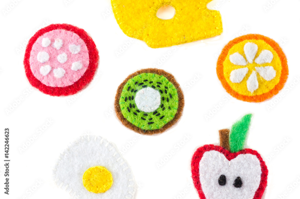 Handmade toy in the form of fruits and food made of felt . Close-up of crafts with embroidery Handmade toy in the form of fruits and food made of felt . Close-up of crafts with embroidery